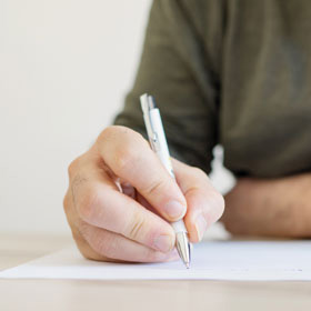 person writing a letter